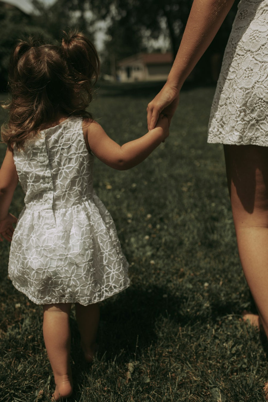 A little girl holding her mother's hand